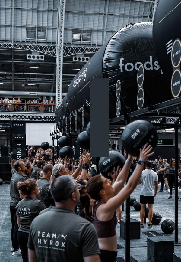 Hyrox athletes performing wallballs at a hyrox event